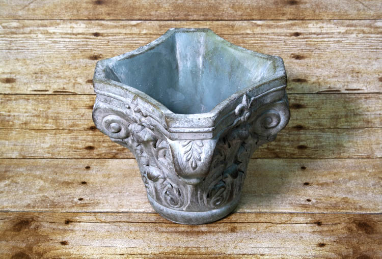 Bring a sense of nobility to your indoor garden with this planter resembling a column's echinus.